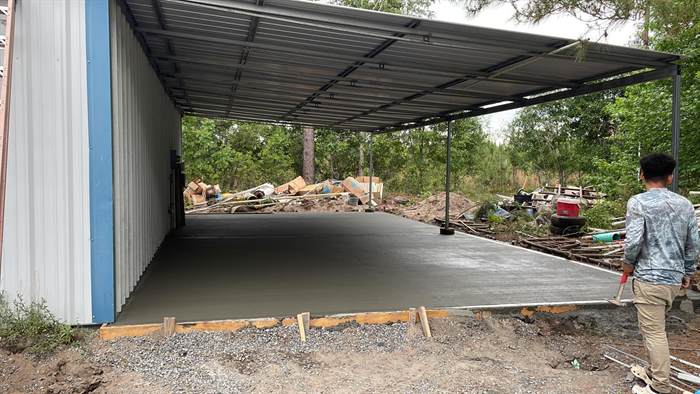 Finished smooth concrete floor under a covered pole barn structure