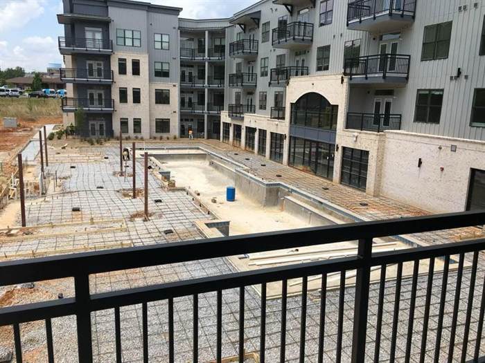 Reinforcing steel laid across a courtyard and pool deck between apartment buildings