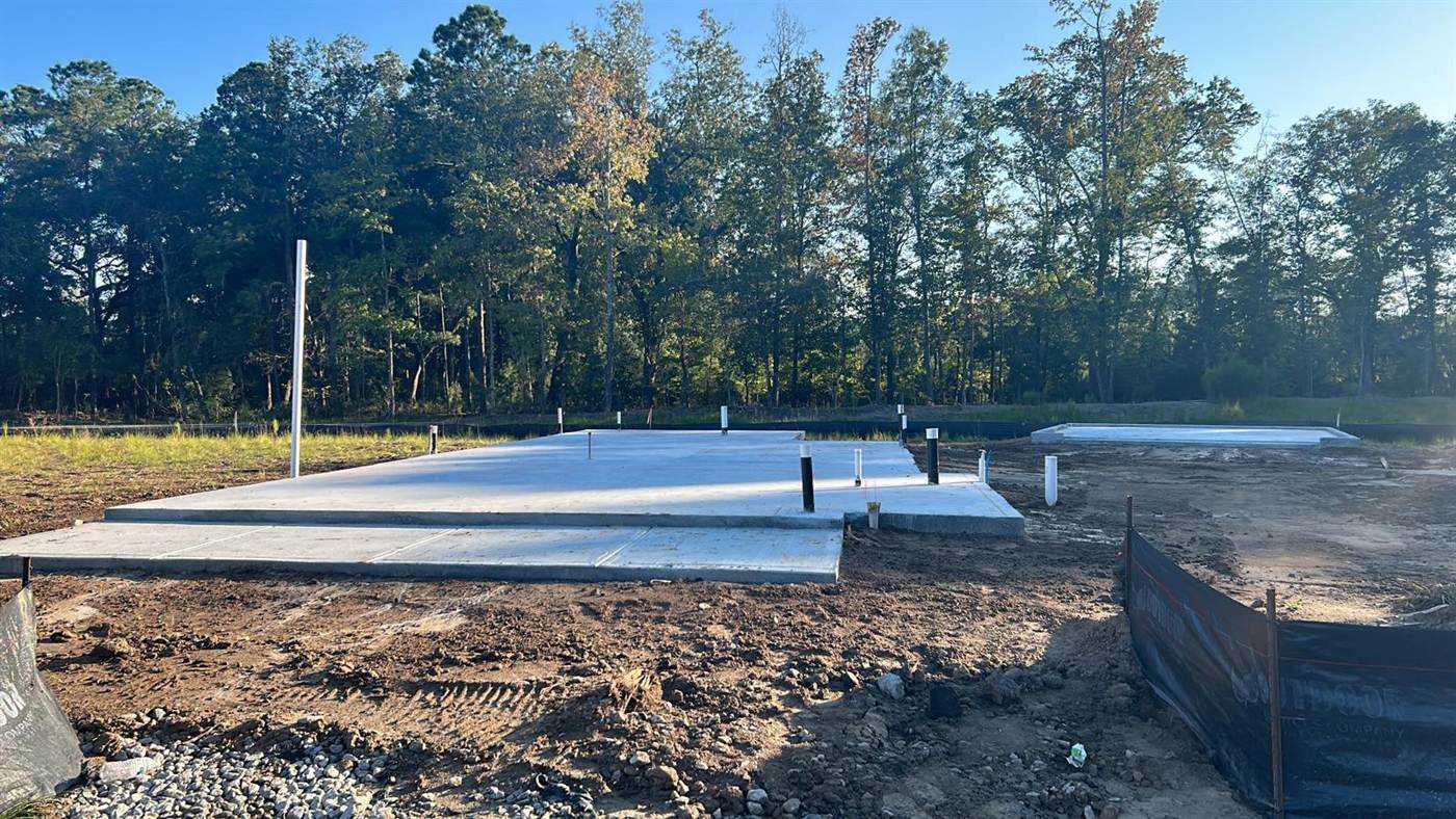 Finished monolithic concrete slab with an integral turned-down edge and a stepped porch section