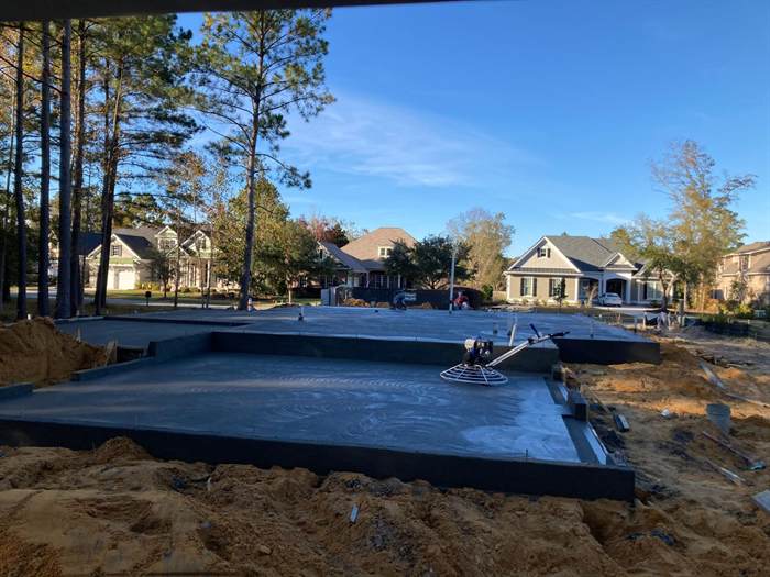 Freshly trowelled slab with a power trowel parked on the surface in an established neighbourhood